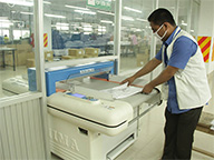 Manufacturer photo of man in blue shirt operating machine Manufacturer photo of man in blue shirt operating machine